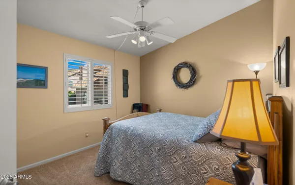 a bedroom with a bed couch and a window