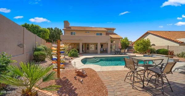 a view of a backyard with furniture and a patio