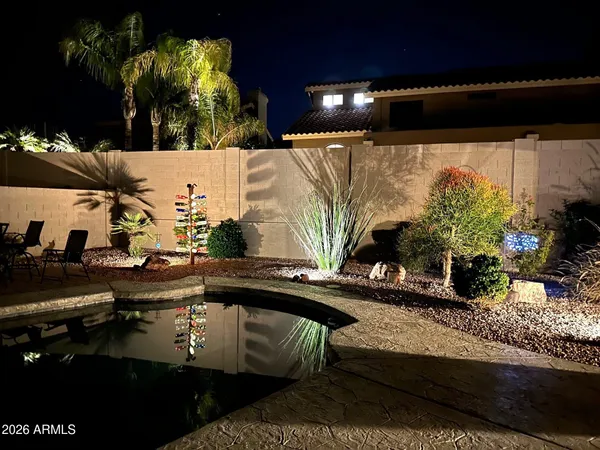a view of a house with backyard and sitting area