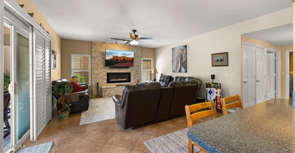 a view of a patio with table and chairs with wooden floor and fence