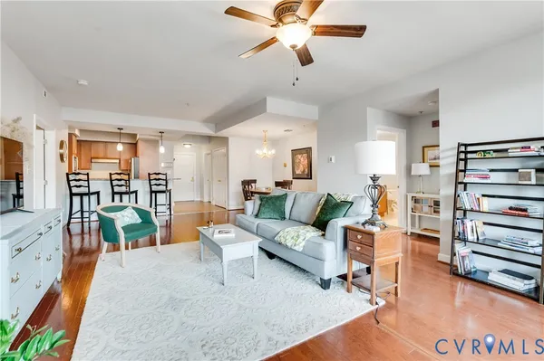 a living room with furniture and a wooden floor