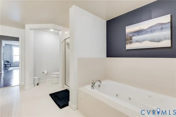 a bathroom with a tub toilet and sink