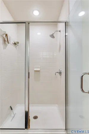 a bathroom with a glass shower door