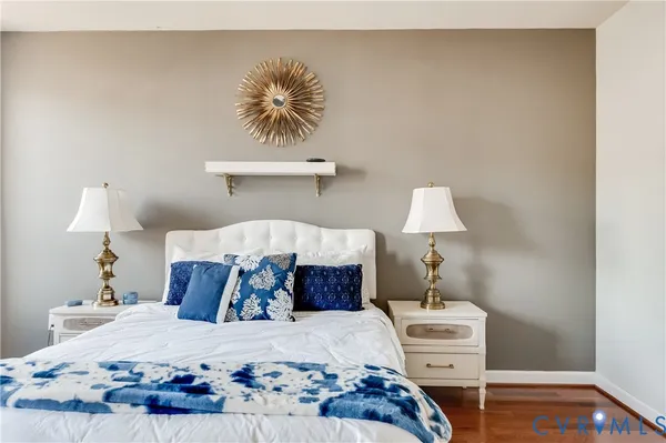 a bedroom with a bed and lamps