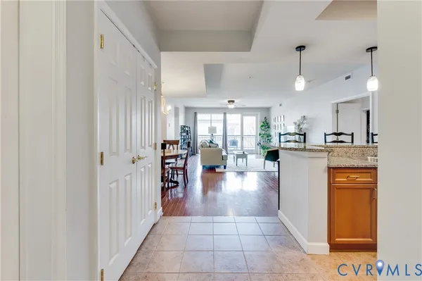 a view of a kitchen with refrigerator and a living room