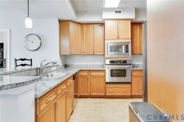 a kitchen with stainless steel appliances granite countertop a stove and a sink