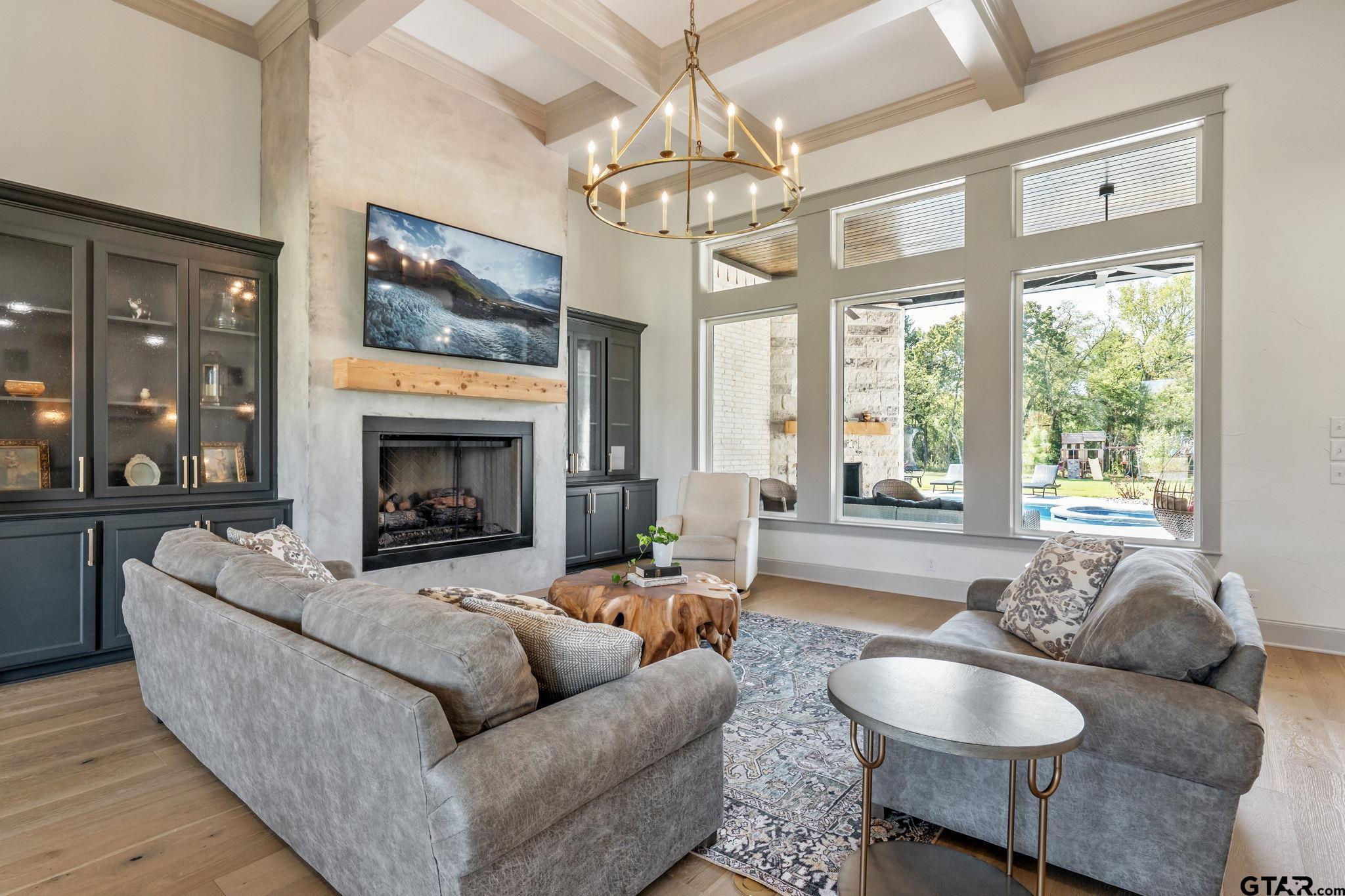 15601 Stampede Run Tyler, TX 75703 - Photo 11 of 48 a living room with furniture a chandelier and a fireplace