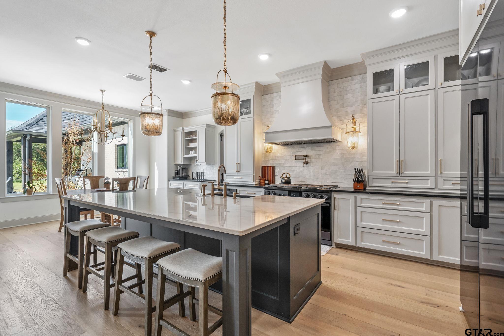 15601 Stampede Run Tyler, TX 75703 - Photo 14 of 48 a large kitchen with a table and chairs