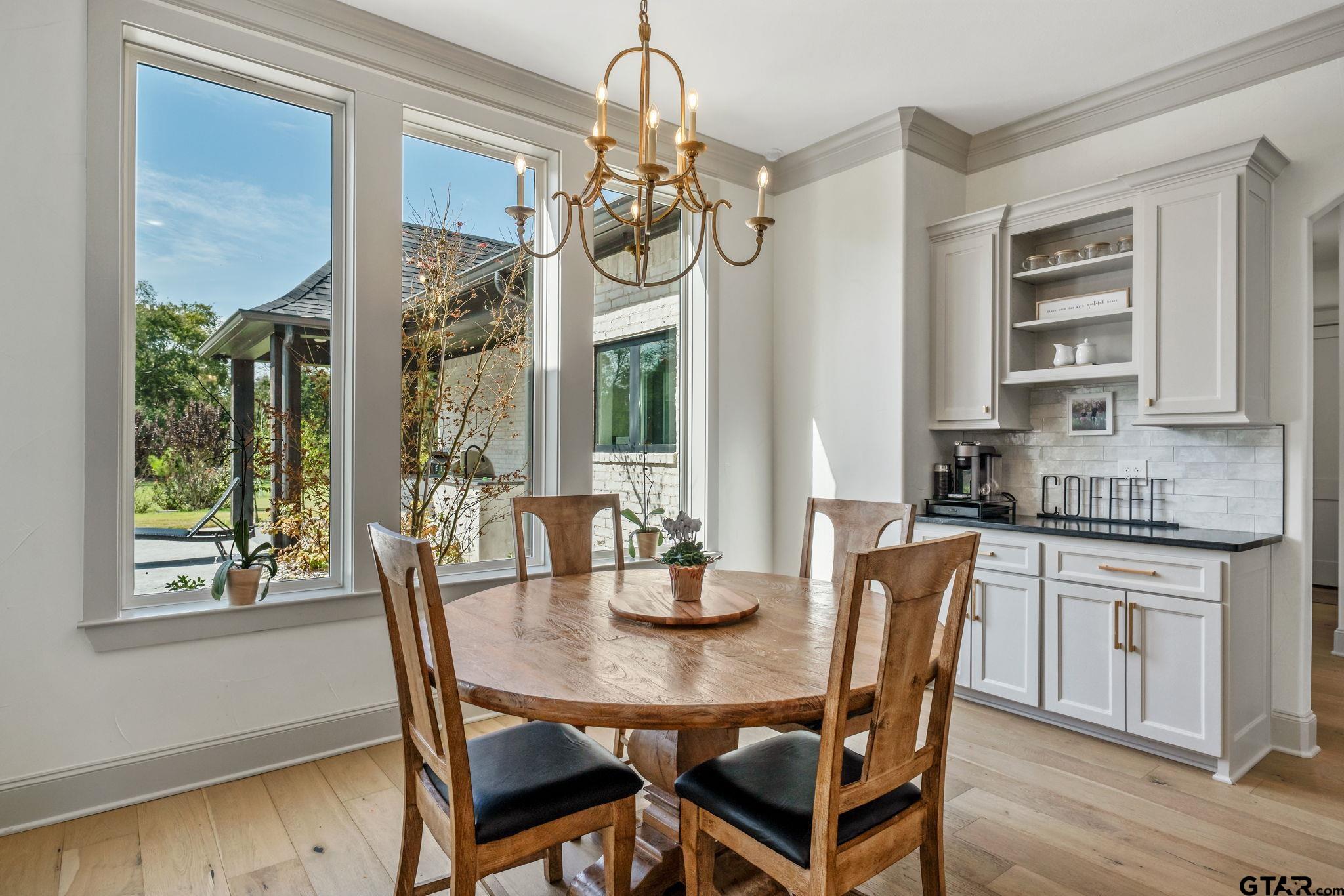 15601 Stampede Run Tyler, TX 75703 - Photo 18 of 48 a dining room with furniture a chandelier and wooden floor