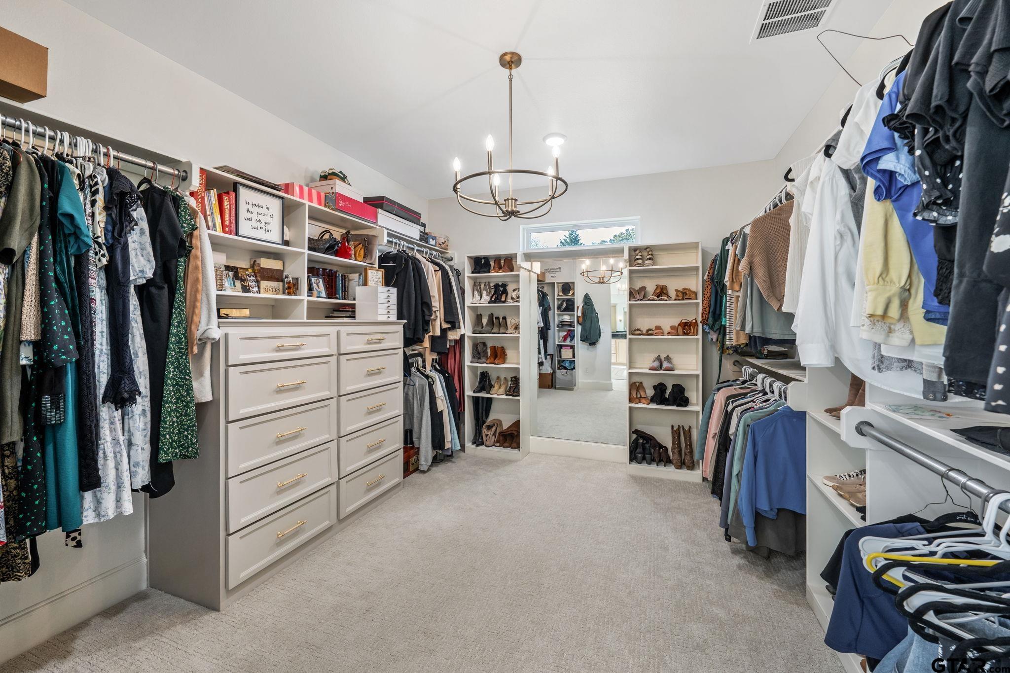 15601 Stampede Run Tyler, TX 75703 - Photo 25 of 48 a view of walk in closet with clothes and shoes