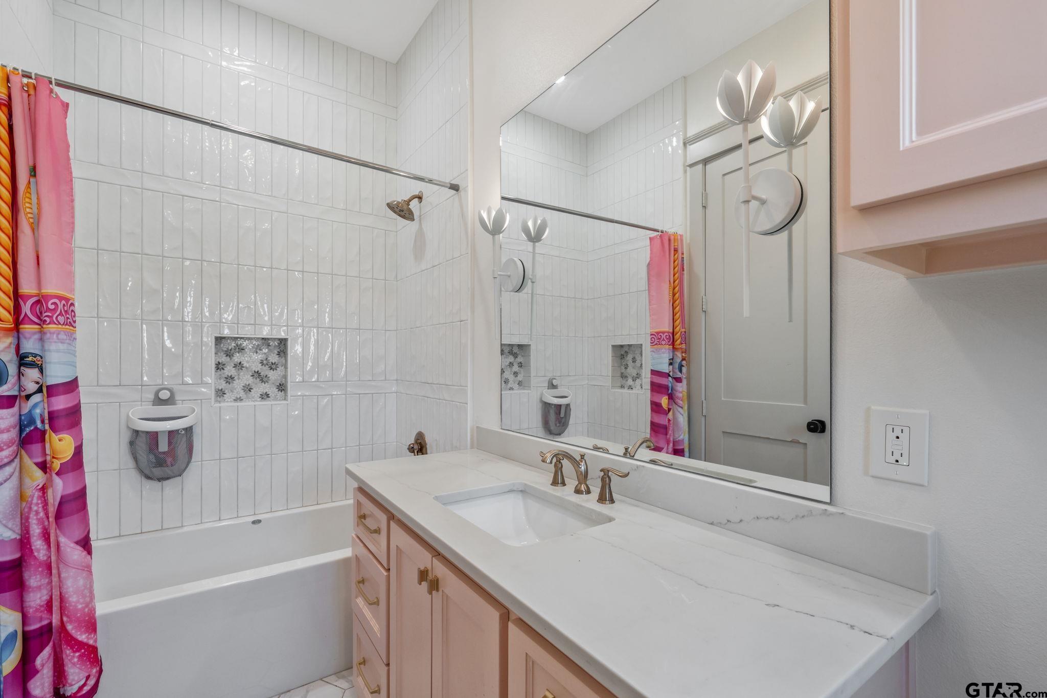 15601 Stampede Run Tyler, TX 75703 - Photo 37 of 48 a bathroom with a granite countertop sink a toilet and shower