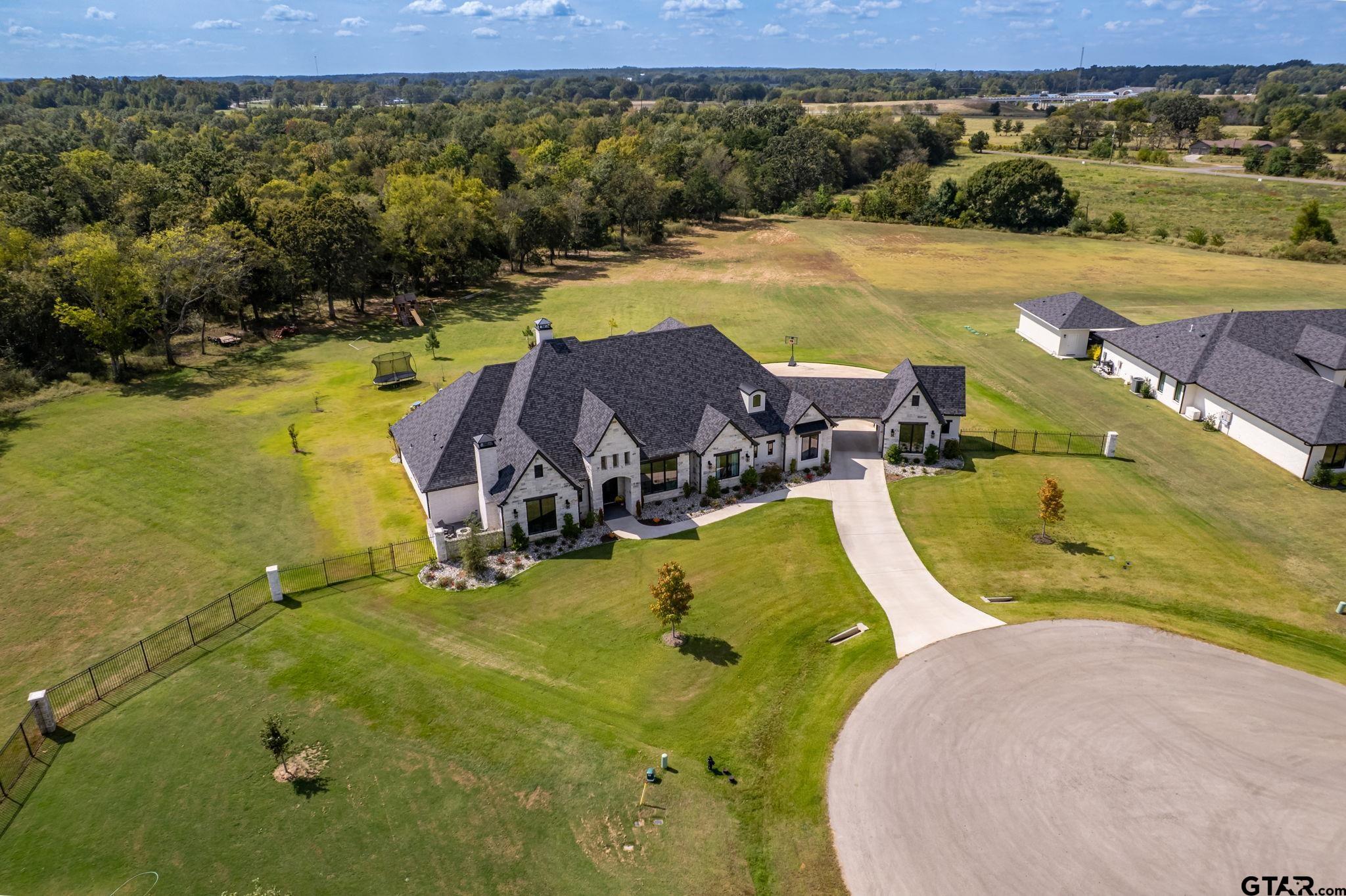 15601 Stampede Run Tyler, TX 75703 - Photo 4 of 48 an aerial view of a swimming pool with a yard