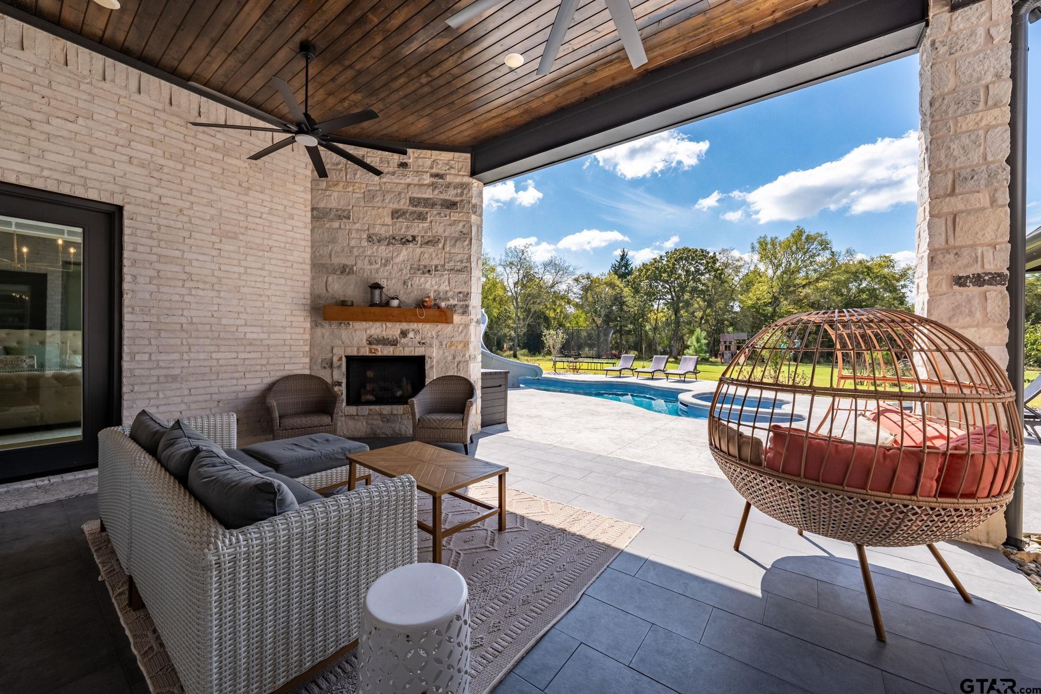 15601 Stampede Run Tyler, TX 75703 - Photo 43 of 48 a outdoor space with patio furniture and a fireplace