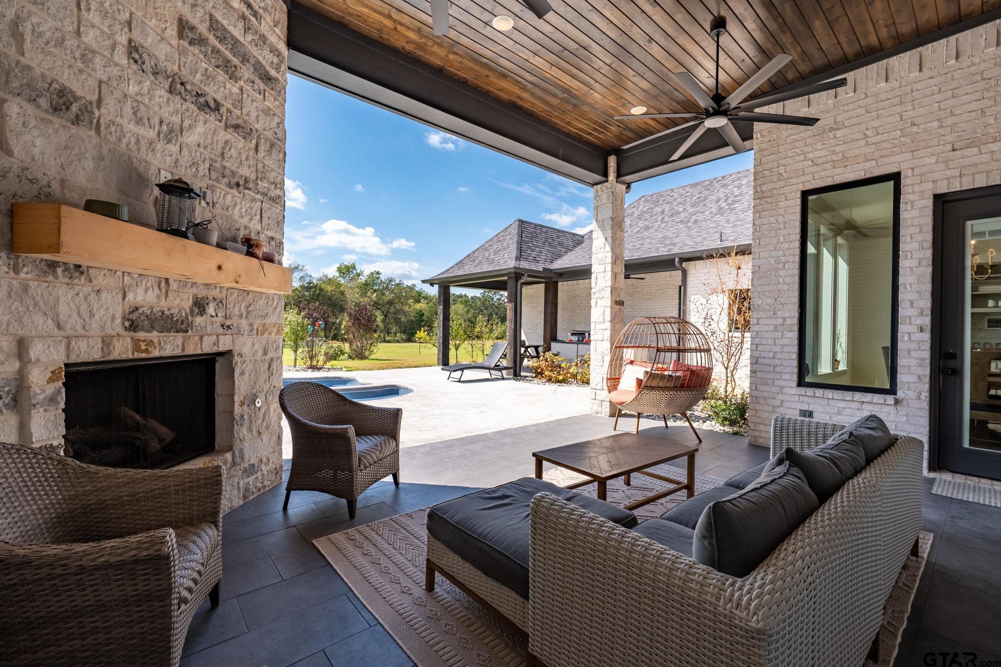 15601 Stampede Run Tyler, TX 75703 - Photo 44 of 48 a living room with furniture a fireplace and a table