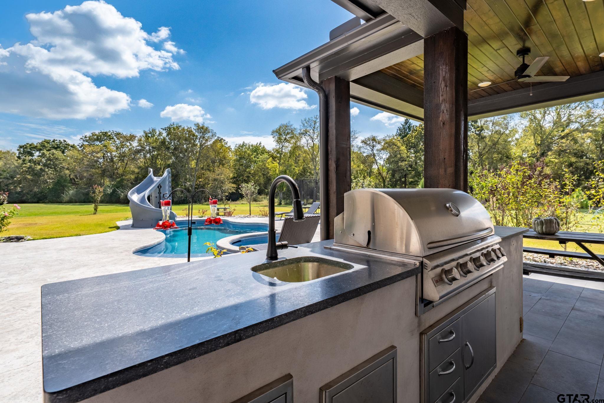 15601 Stampede Run Tyler, TX 75703 - Photo 45 of 48 a kitchen with a stove and a wooden floor