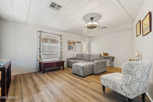 a living room with furniture and a wooden floor