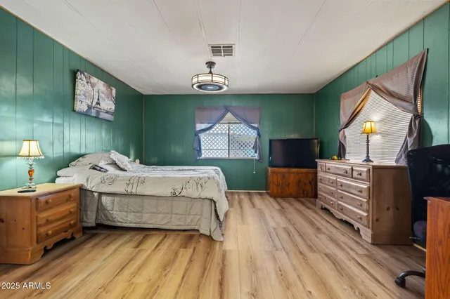 a bedroom with a bed and a dresser