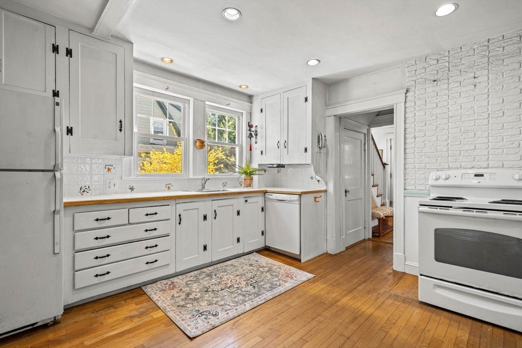 71 Woodside Road Winchester, MA 01890 - Photo 19 of 40 a kitchen with stainless steel appliances a stove a refrigerator and a cabinets