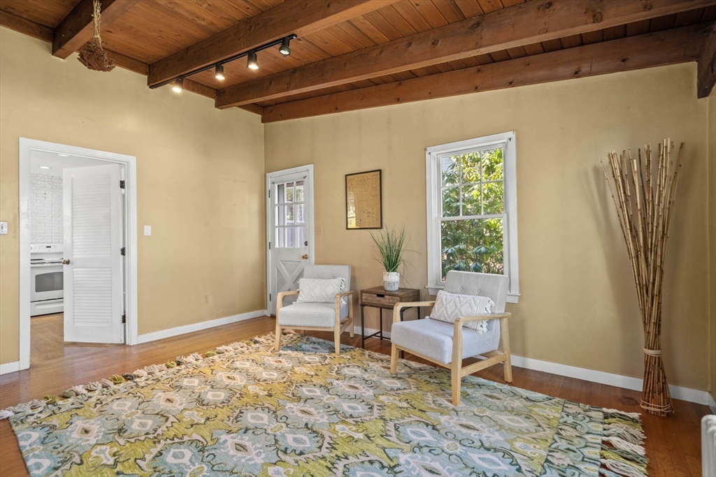 71 Woodside Road Winchester, MA 01890 - Photo 24 of 40 a living room with a rug and a table