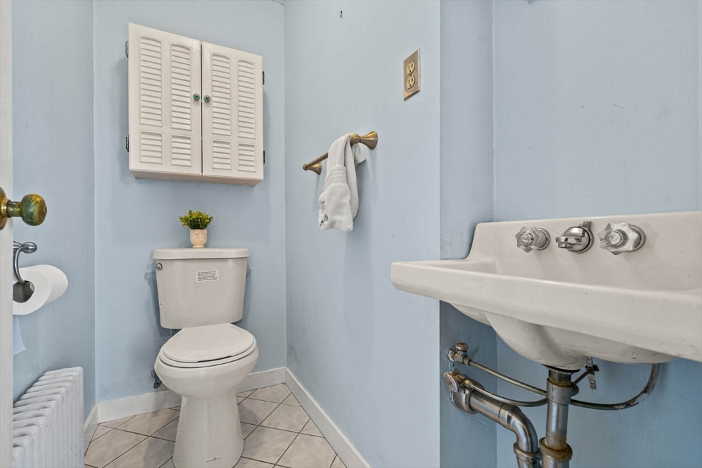 71 Woodside Road Winchester, MA 01890 - Photo 25 of 40 a white toilet sitting next to a bathroom sink