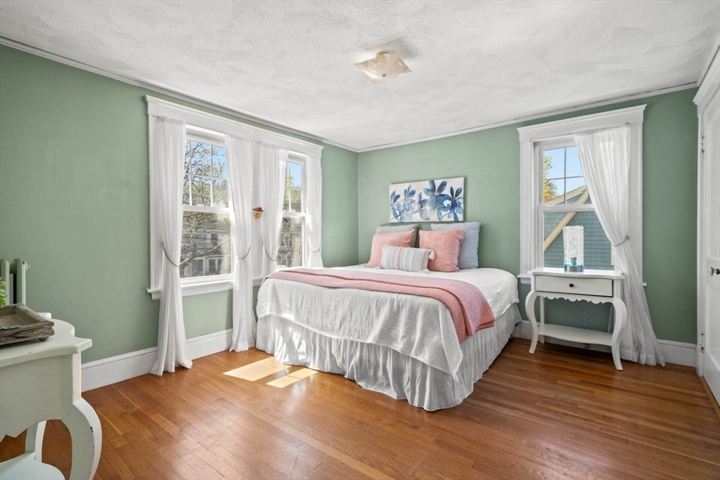 71 Woodside Road Winchester, MA 01890 - Photo 26 of 40 a bedroom with a bed and wooden floor