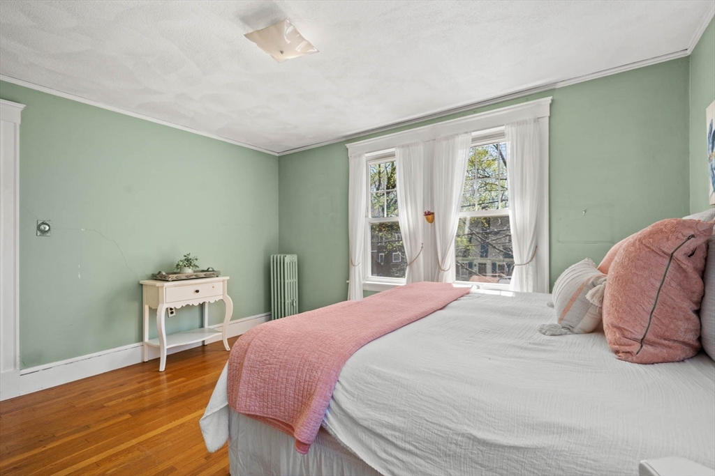 71 Woodside Road Winchester, MA 01890 - Photo 27 of 40 a bedroom with a bed and wooden floor