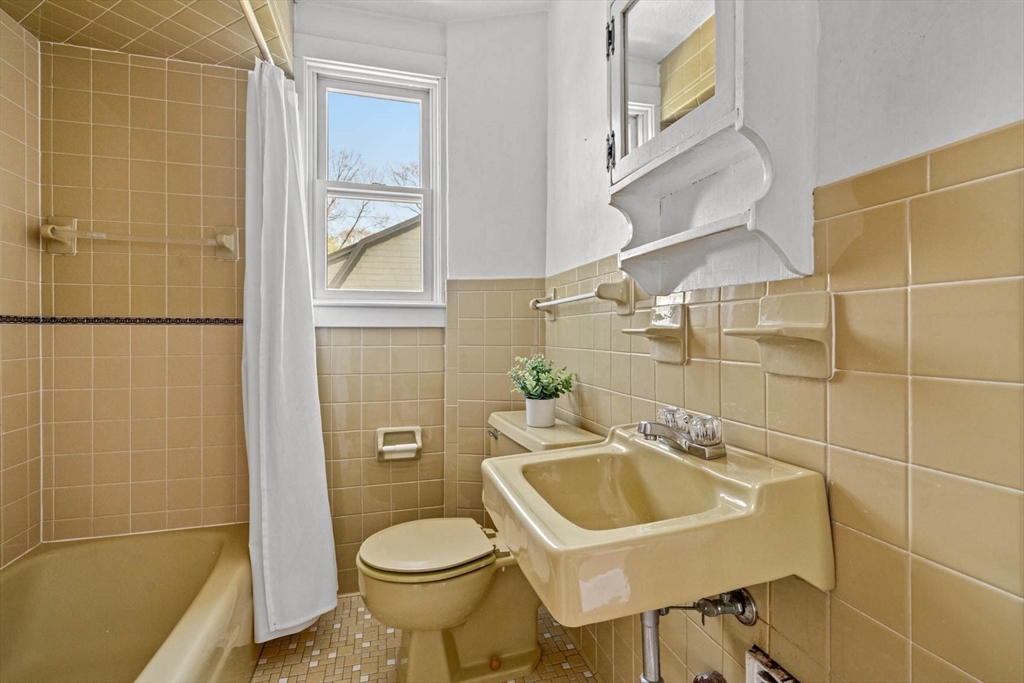 71 Woodside Road Winchester, MA 01890 - Photo 29 of 40 a bathroom with a sink a toilet and shower