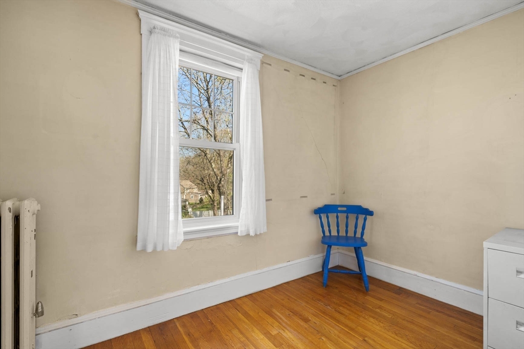 71 Woodside Road Winchester, MA 01890 - Photo 30 of 40 a room with a window and wooden floor