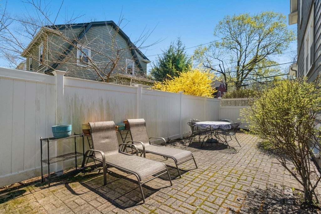 71 Woodside Road Winchester, MA 01890 - Photo 33 of 40 a backyard of a house with table and chairs