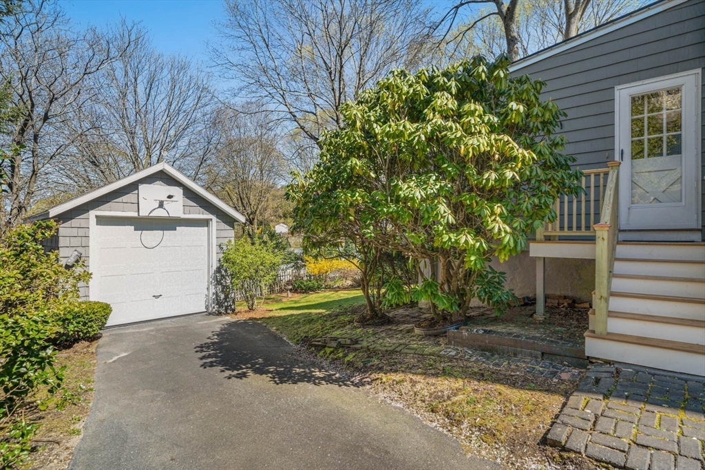 71 Woodside Road Winchester, MA 01890 - Photo 35 of 40 a view of a house with a yard and garage