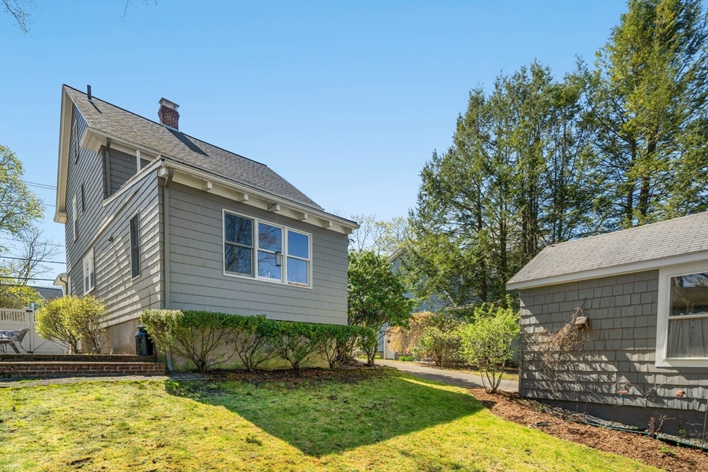 71 Woodside Road Winchester, MA 01890 - Photo 6 of 40 a front view of a house with a yard