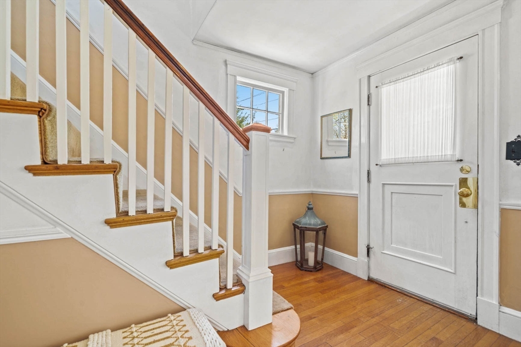 71 Woodside Road Winchester, MA 01890 - Photo 7 of 40 a view of front door with hallway and wooden floor