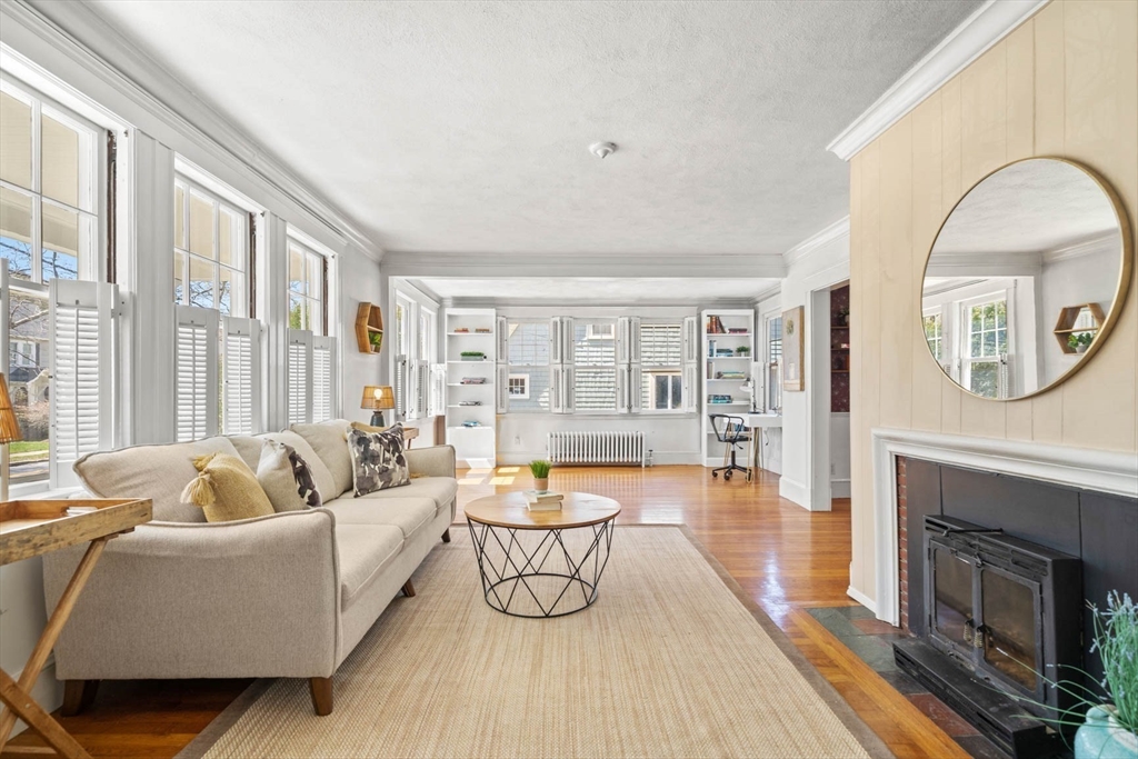 71 Woodside Road Winchester, MA 01890 - Photo 8 of 40 a living room with furniture a fireplace and a large window