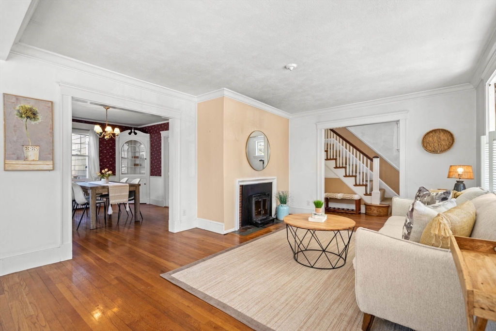 71 Woodside Road Winchester, MA 01890 - Photo 9 of 40 a living room with furniture a fireplace and a large window