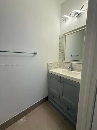 a bathroom with a double vanity sink toilet and shower