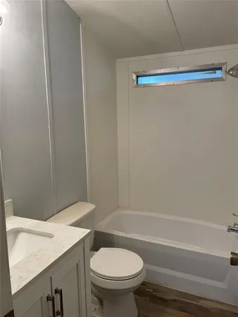 a bathroom with a sink a toilet and a shower