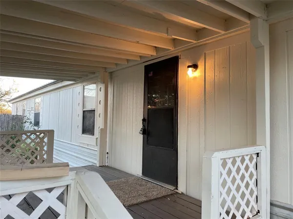 a view of a wooden door and outdoor space