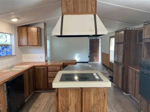 a kitchen that has a sink a stove and a refrigerator