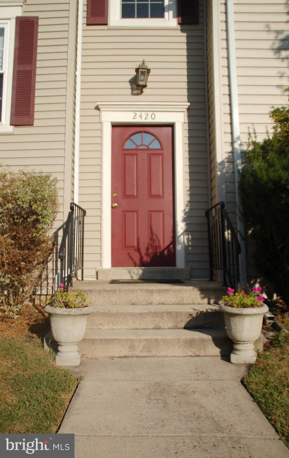2420 Ridgehampton Court Reston, VA 20191 - Photo 2 of 16 a front view of a house with a fountain and a fire pit