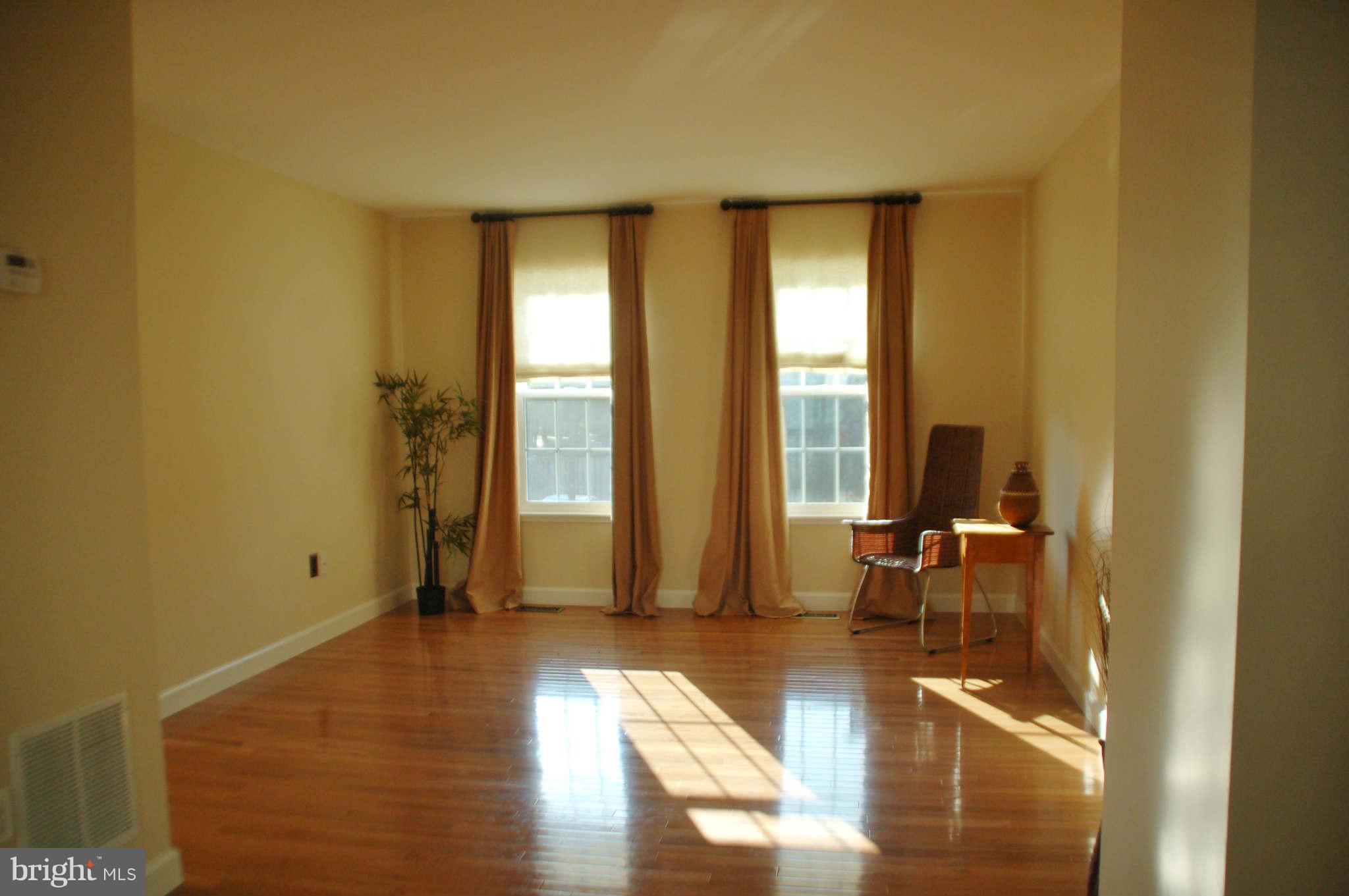2420 Ridgehampton Court Reston, VA 20191 - Photo 4 of 16 a view of empty room with wooden floor and fan