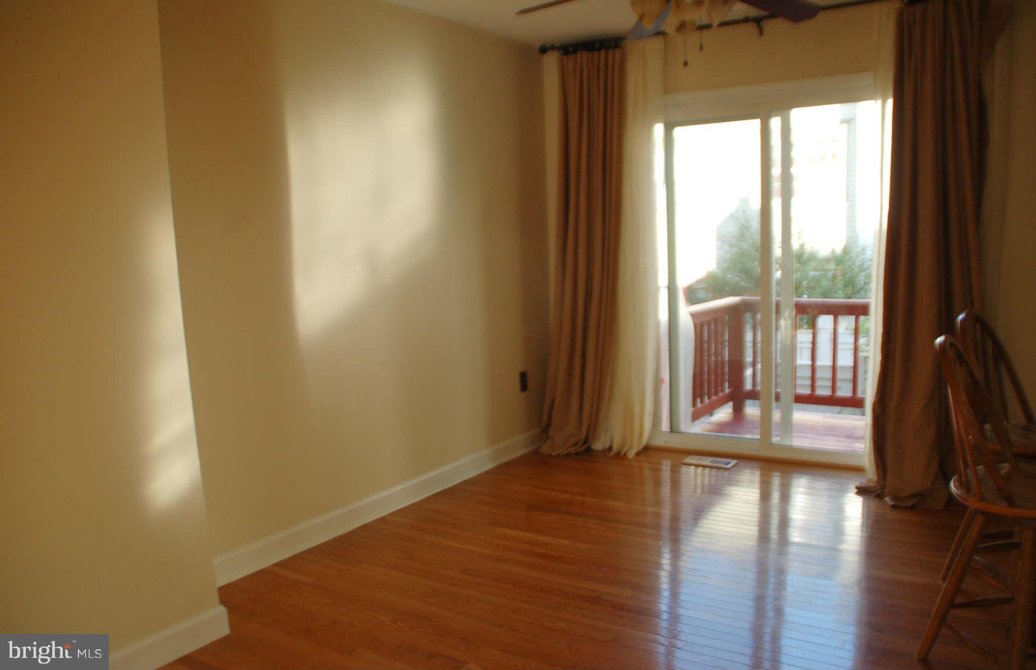 2420 Ridgehampton Court Reston, VA 20191 - Photo 5 of 16 a view of an empty room with wooden floor and a window