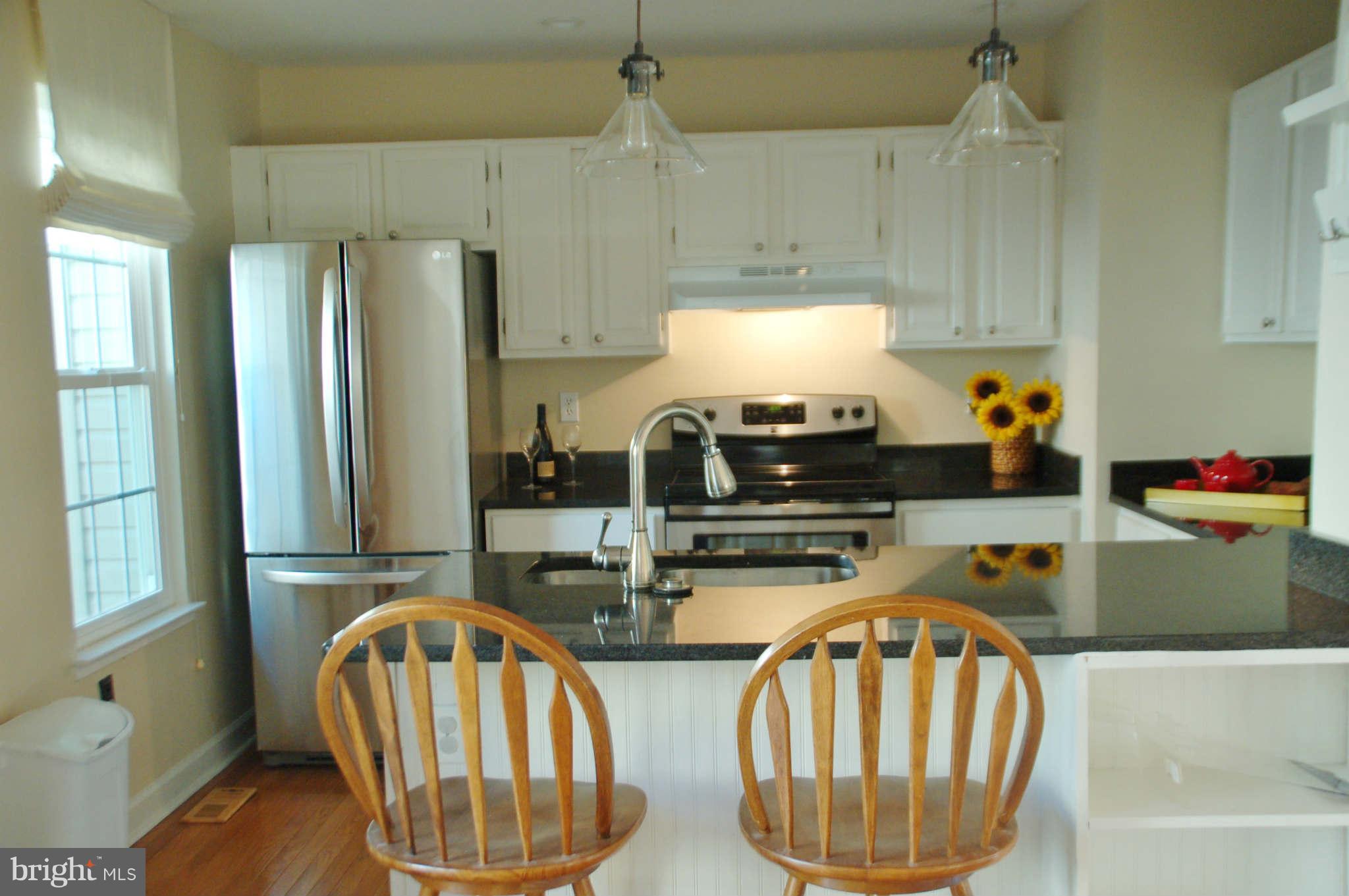 2420 Ridgehampton Court Reston, VA 20191 - Photo 6 of 16 a kitchen with stainless steel appliances a stove a sink and a refrigerator