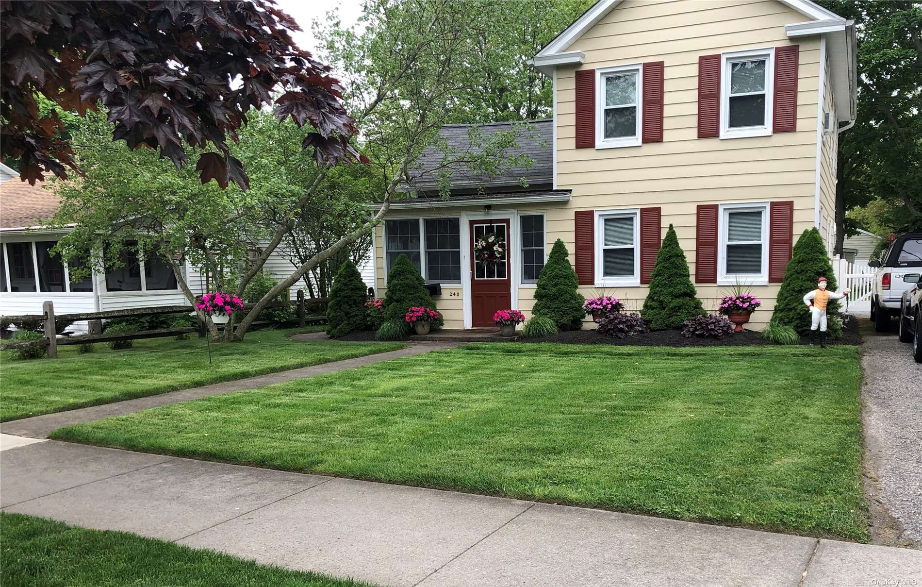 240 Cedar Avenue Patchogue, NY 11772 - Photo 1 of 1 a front view of a house with garden