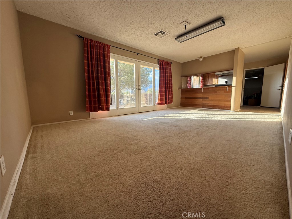 243 Balboa Avenue Mojave, CA 93501 - Photo 58 of 75 a view of room with window and a ceiling fan