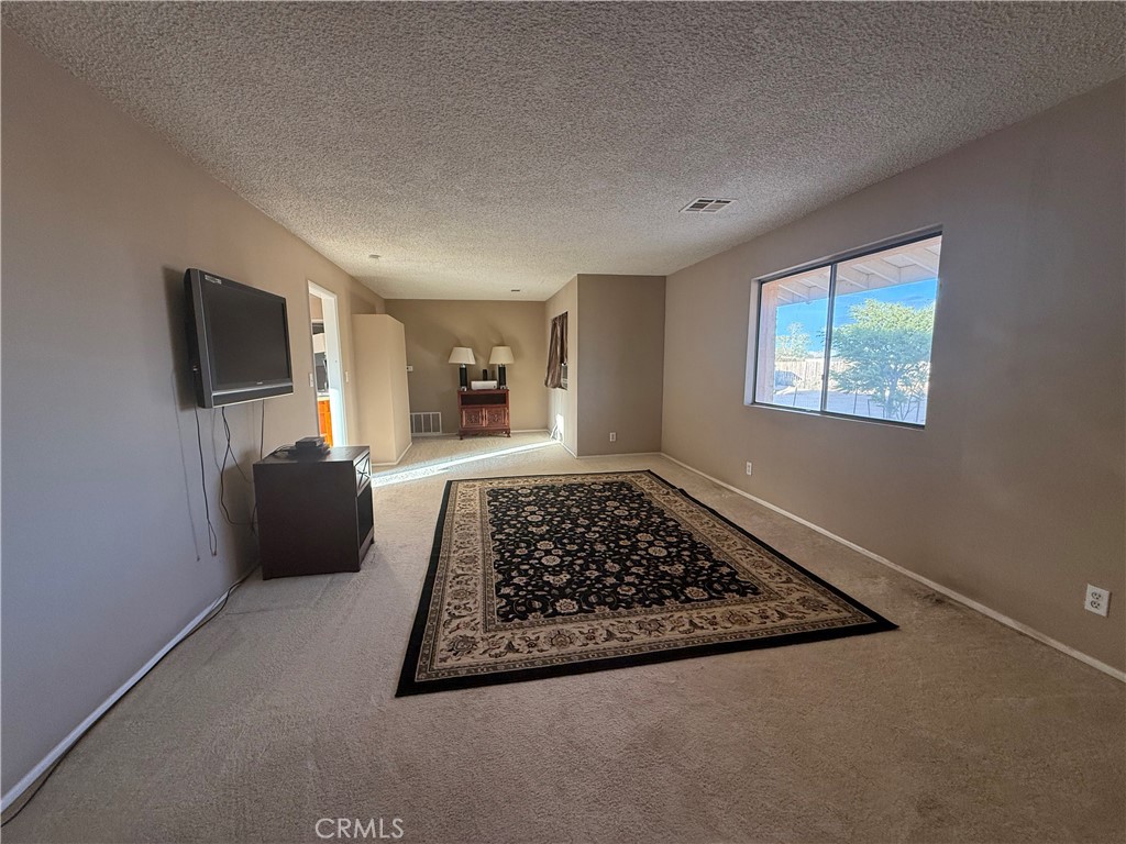 243 Balboa Avenue Mojave, CA 93501 - Photo 59 of 75 a living room with rug rug and a window