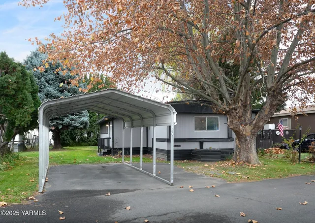 a patio with a table and chairs under an umbrella
