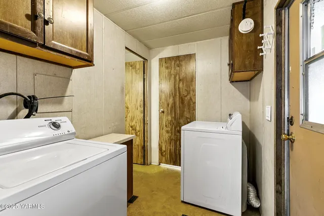 a view of bathroom with a washer and dryer