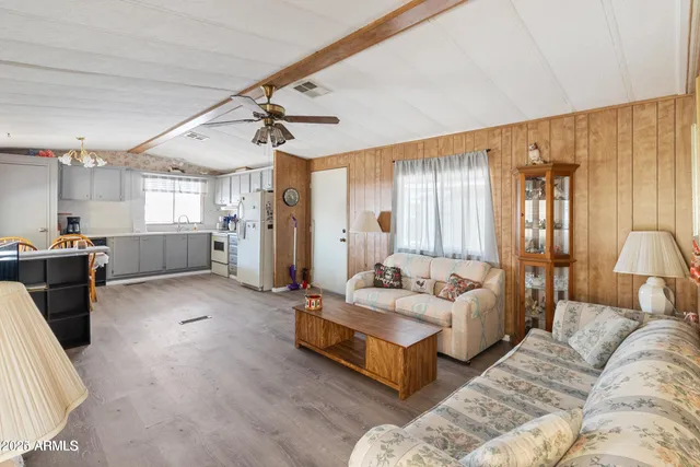 a bedroom with a large bed and a large mirror