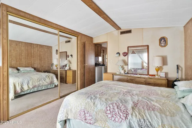 a spacious bedroom with a bed and a dresser