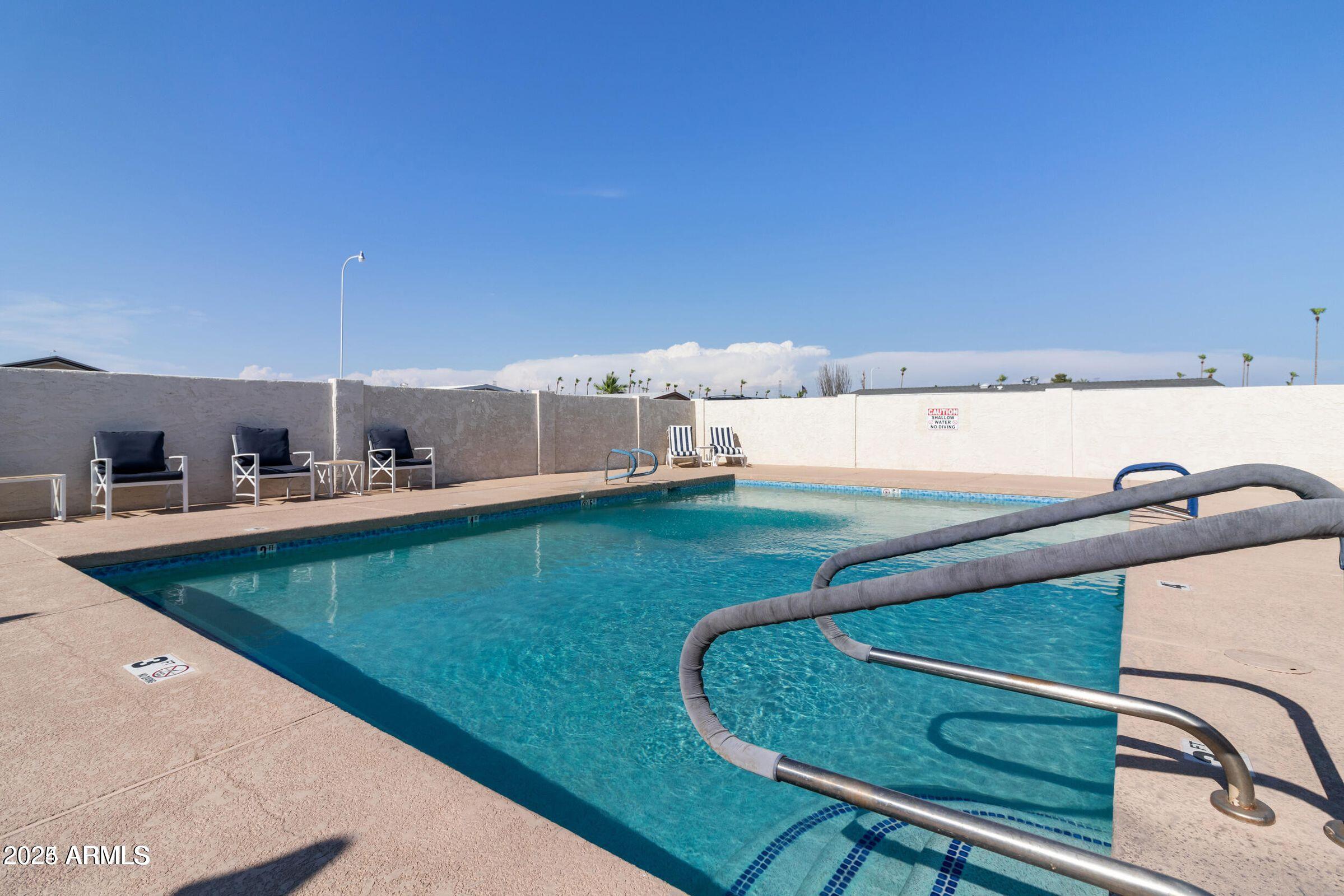 3330 East Main Street, Unit 9 Mesa, AZ 85213 - Photo 18 of 21 a view of a living room with a swimming pool